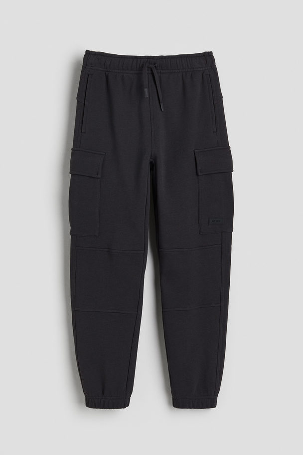 H&M DryMove™ Cargo-Joggpants aus Baumwolle Schwarz