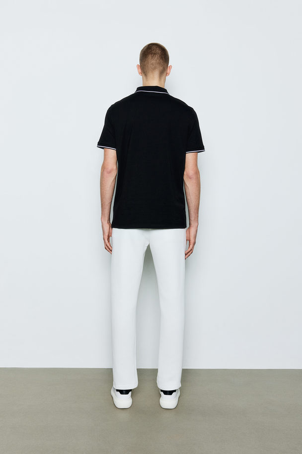 H&M Poloshirt mit Zipper in Slim Fit Schwarz