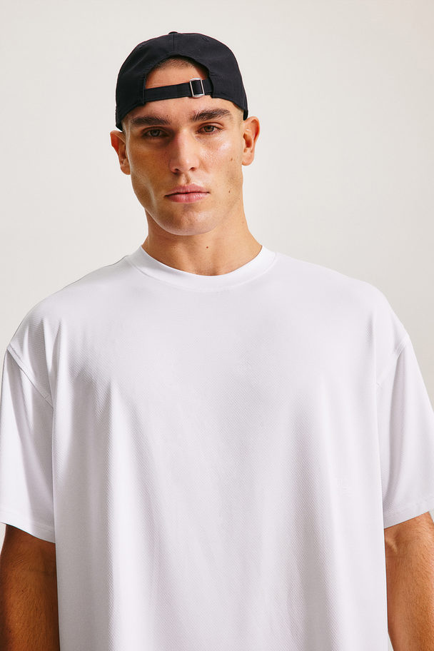 H&M DryMove™ Sportshirt in Loose Fit Weiß/Move 90