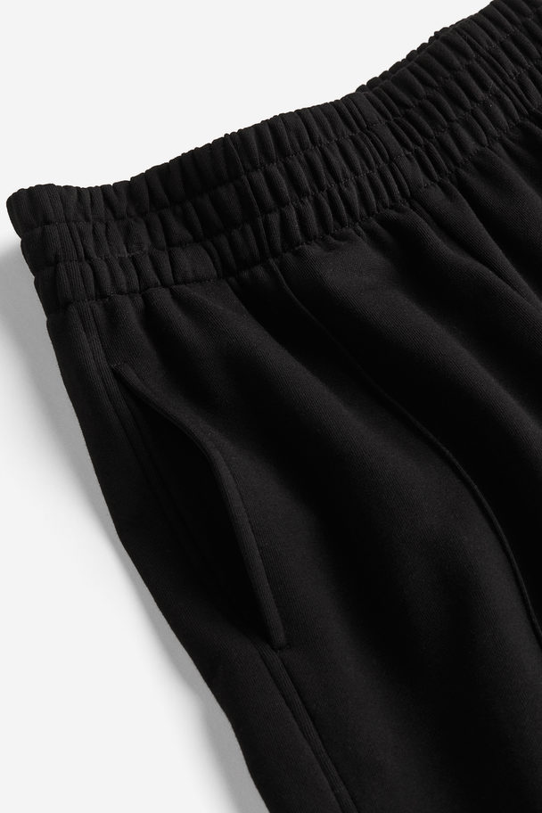 H&M Weite Joggpants aus Baumwolle Schwarz