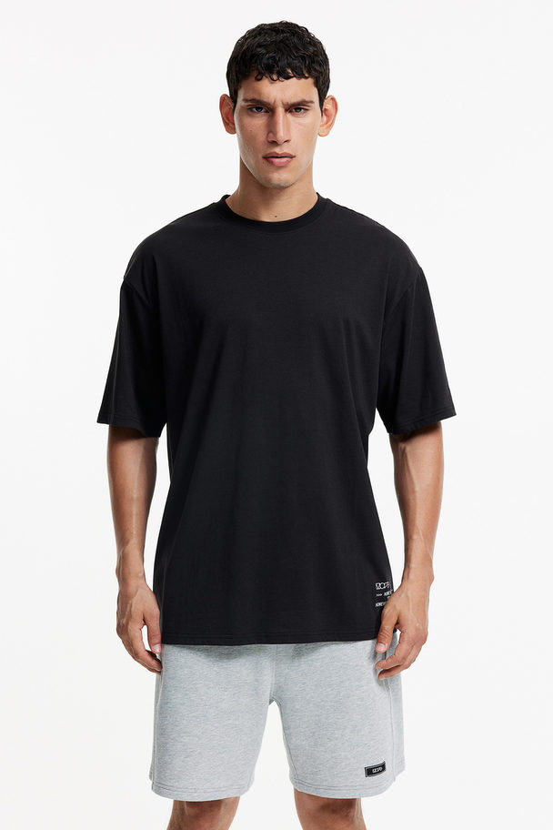 H&M Sportshirt Van Katoen-achtig Drymove™ - Loose Fit Zwart