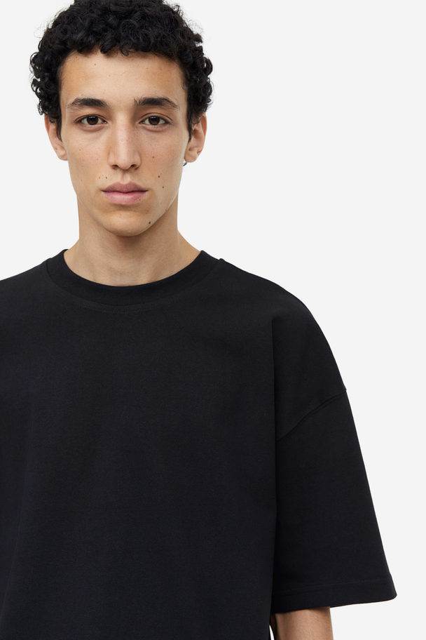 H&M Baumwoll-T-Shirt in Oversize-Passform Schwarz