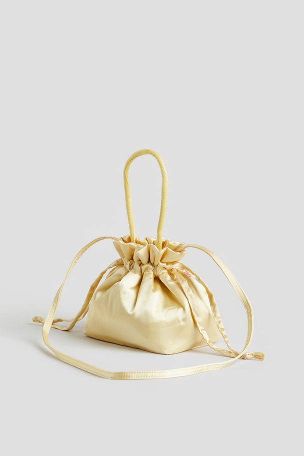H&M Bucket Bag aus Satin mit Motivstickerei Hellgelb/Blumen