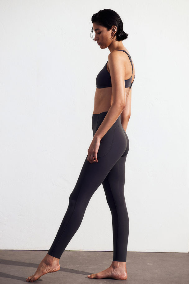 H&M DryMove™ Sportleggings mit Taschendetails Stahlblau