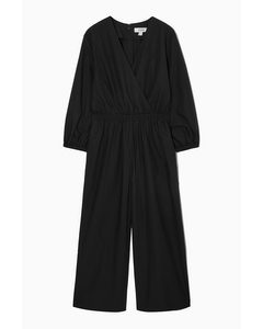 JUMPSUIT MIT WEITEM BEIN UND V-AUSSCHNITT SCHWARZ