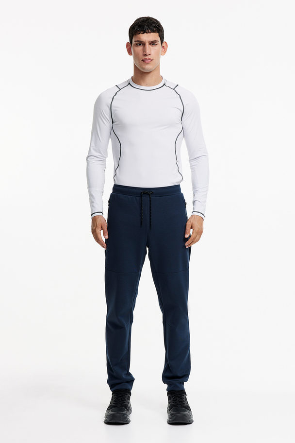 H&M DryMove™ Tapered Tech-Joggpants mit Zippertaschen Marineblau