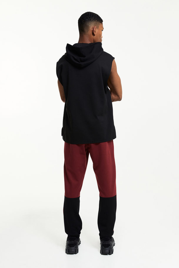 H&M DryMove™ Tapered Tech-Joggpants mit Zippertaschen Dunkelrot/Blockfarben