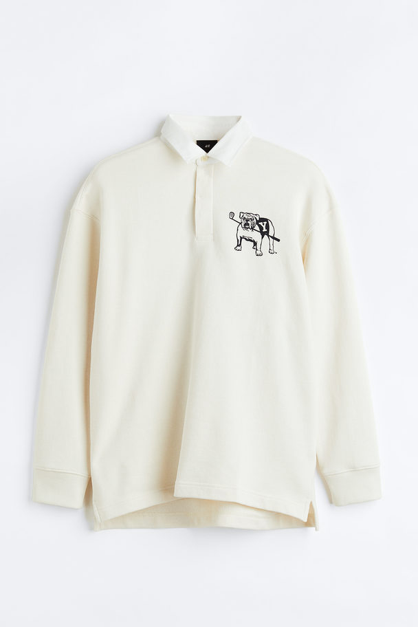 H&M Poloshirt mit Print Relaxed Fit Cremefarben/Yale