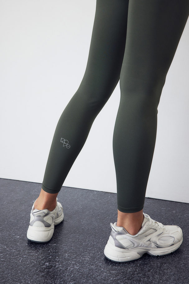 H&M DryMove™ Sportleggings Dunkles Khakigrün