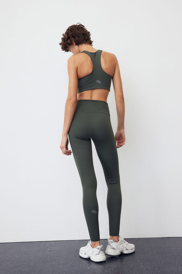 H&M DryMove™ Sportleggings Dunkles Khakigrün