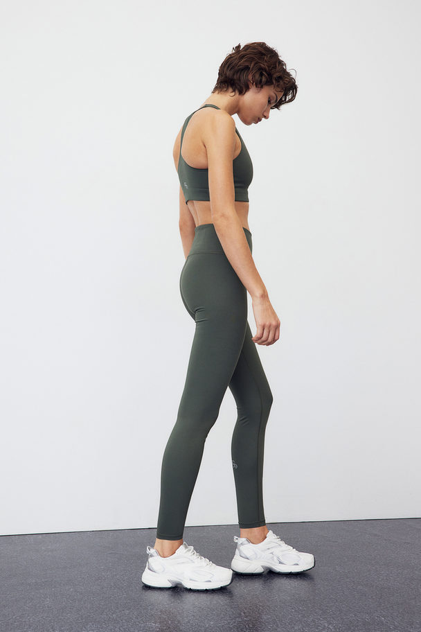 H&M DryMove™ Sportleggings Dunkles Khakigrün