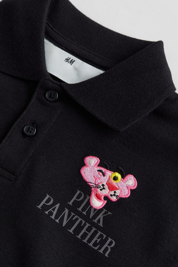 H&M Poloshirt aus Baumwollpikee Schwarz/Rosaroter Panther