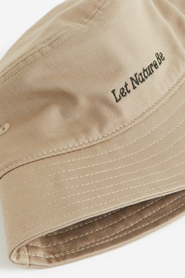 H&M Bucket Hat aus Baumwolle Beige/Let Nature Be