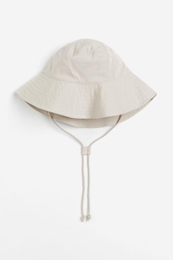 H&M Bucket Hat mit Kinnbändern Hellbeige