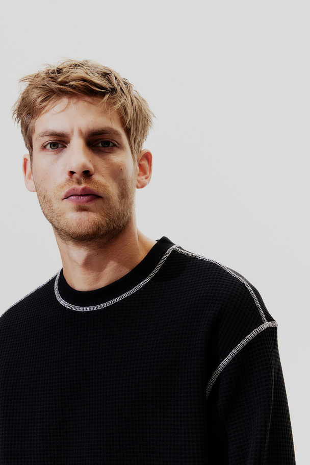 H&M Sweatshirt mit Waffelstruktur in Loose Fit Schwarz
