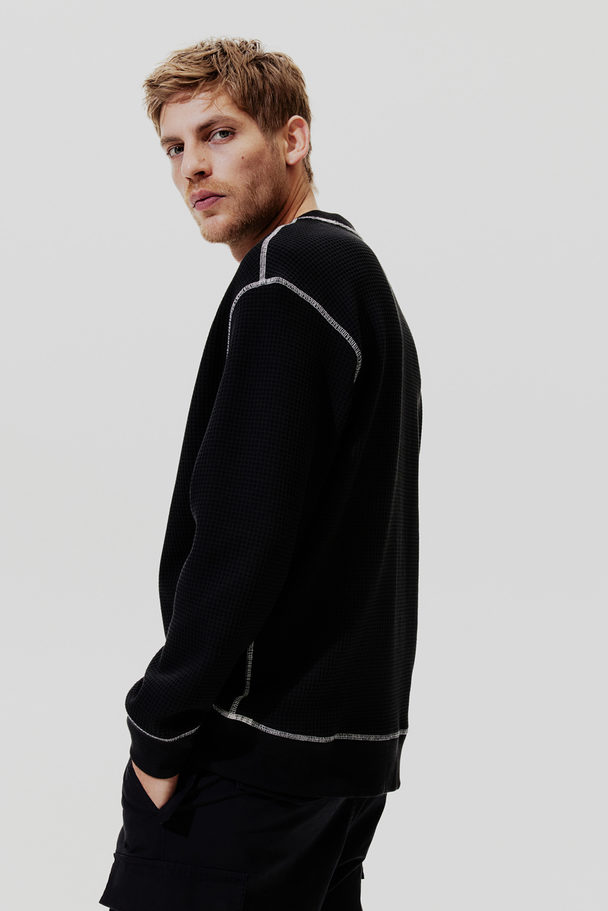 H&M Sweatshirt mit Waffelstruktur in Loose Fit Schwarz