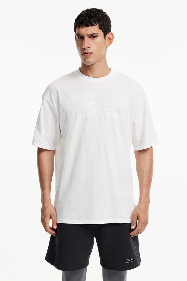 H&M DryMove™ Baumwollartiges Sport-T-Shirt Loose Fit Weiß