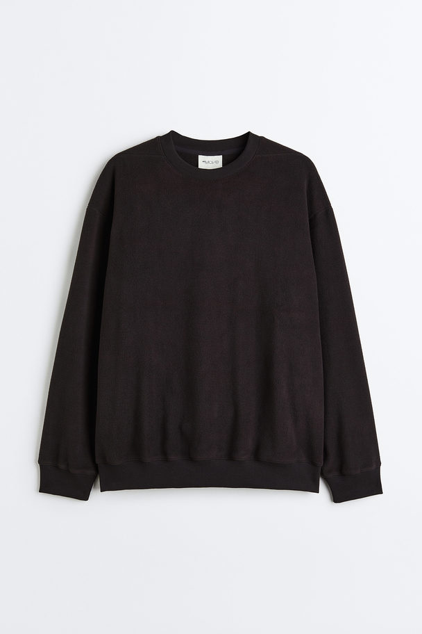 H&M Fleece-Sweatshirt mit Tasche Schwarz