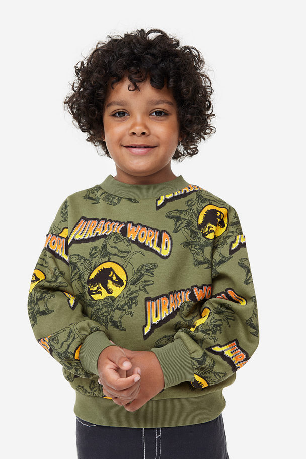 H&M Oversized Sweatshirt mit Print Khakigrün/Jurassic World
