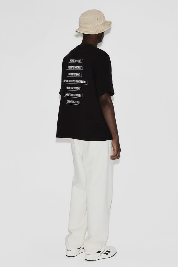 H&M Bedrucktes T-Shirt in Loose Fit Schwarz/Interested