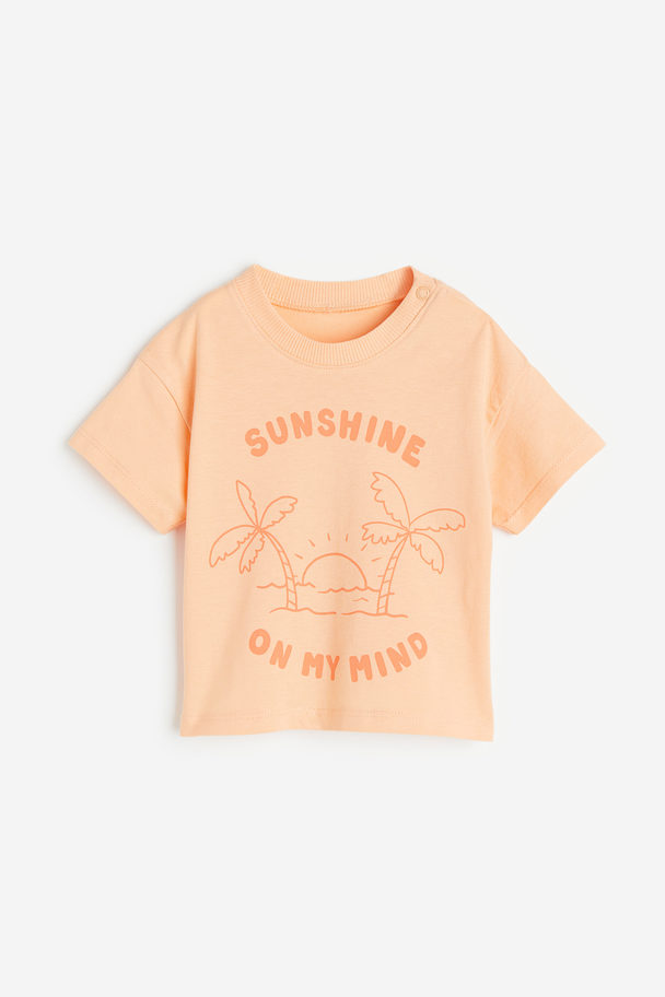 H&M T-Shirt mit Print Apricot/Palmen