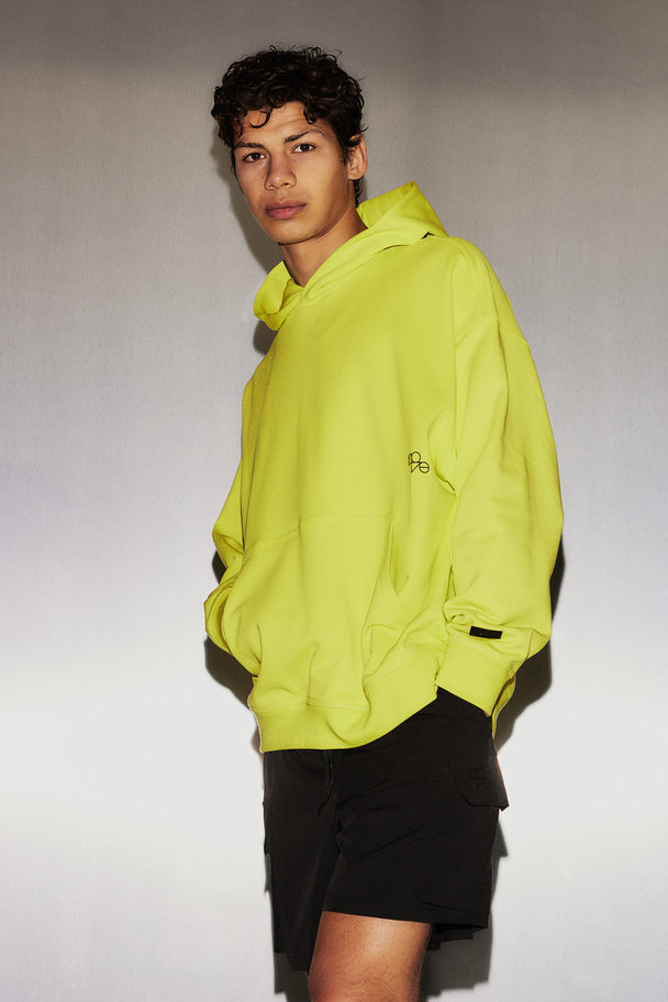 H&M Träningshuvtröja I Drymove™ Loose Fit Neongrön