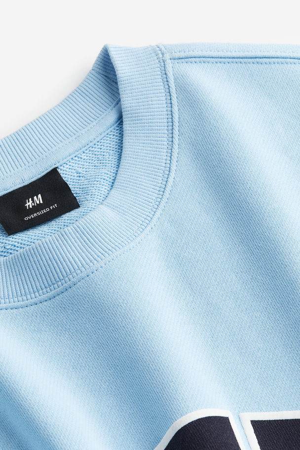 H&M Sweatshirt mit Print Relaxed Fit Hellblau/Whenever