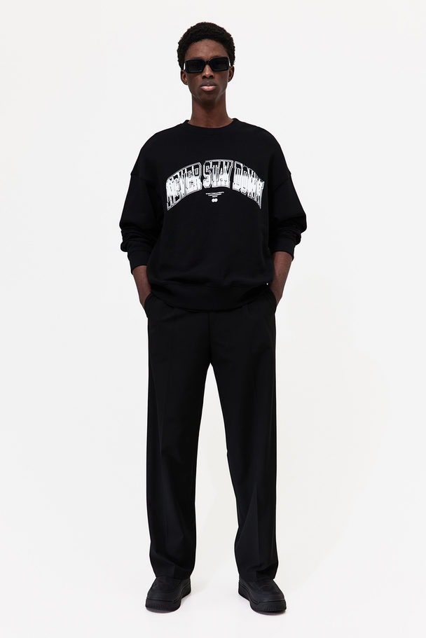 H&M Sweatshirt mit Print Relaxed Fit Schwarz/Never Stay Down