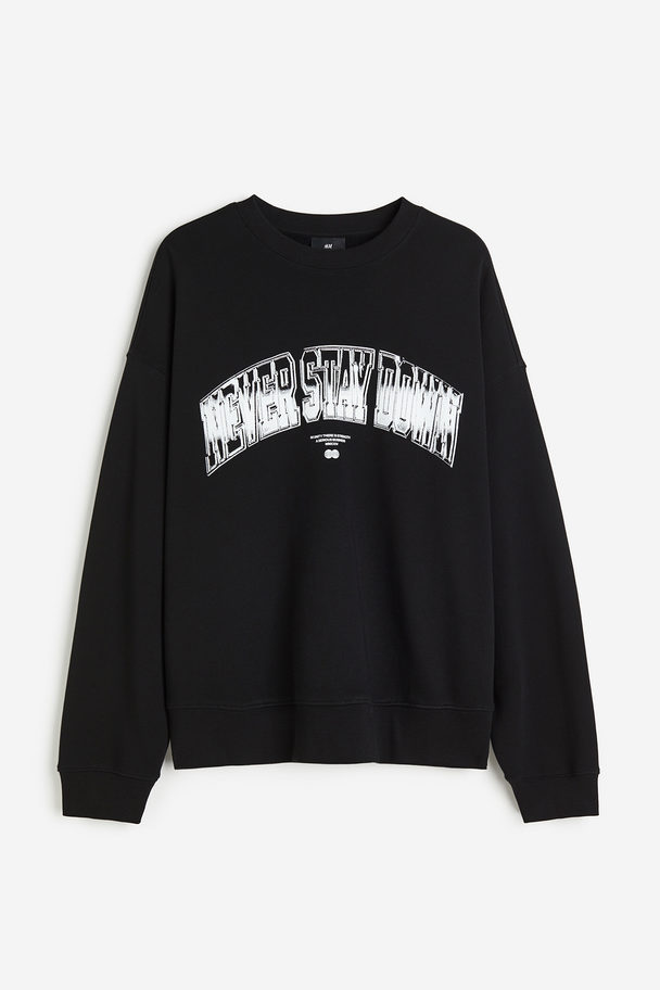 H&M Sweatshirt mit Print Relaxed Fit Schwarz/Never Stay Down