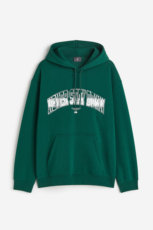 H&M Bedruckter Hoodie in Oversized Fit Grün/Never Stay Down