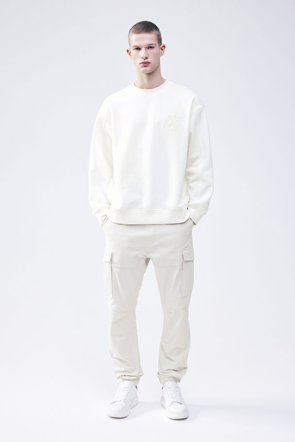 H&M Sweatshirt mit Applikation Relaxed Fit Cremefarben