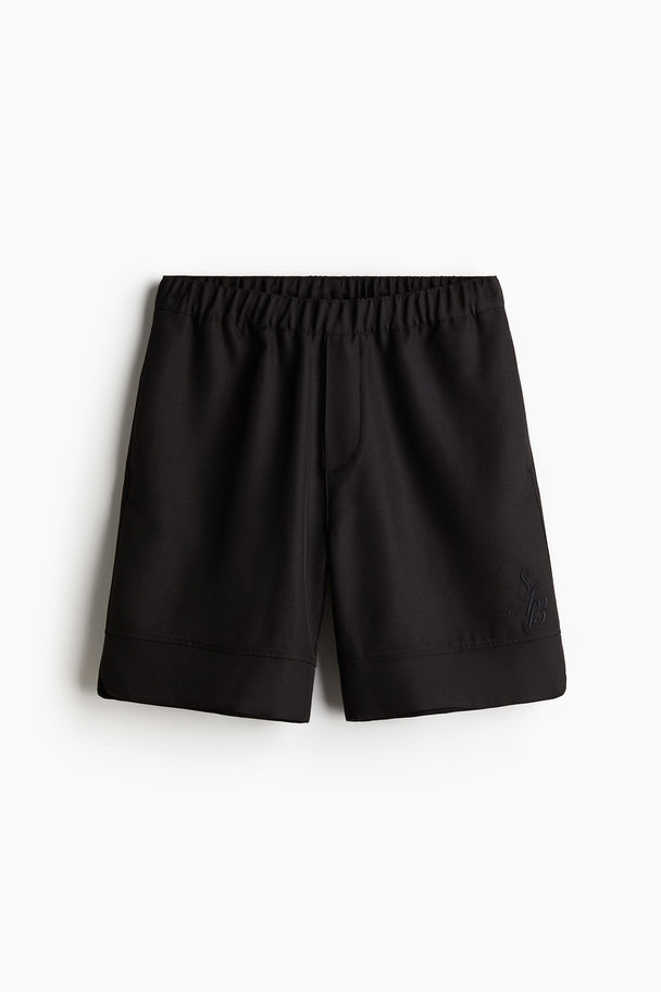 H&M Knielange Shorts in Relaxed Fit Schwarz