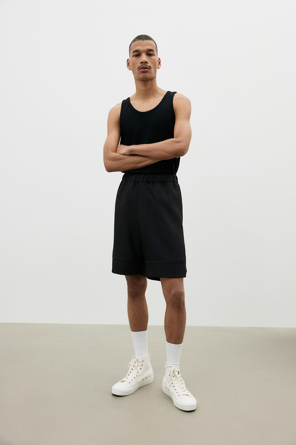 H&M Knielange Shorts in Relaxed Fit Schwarz