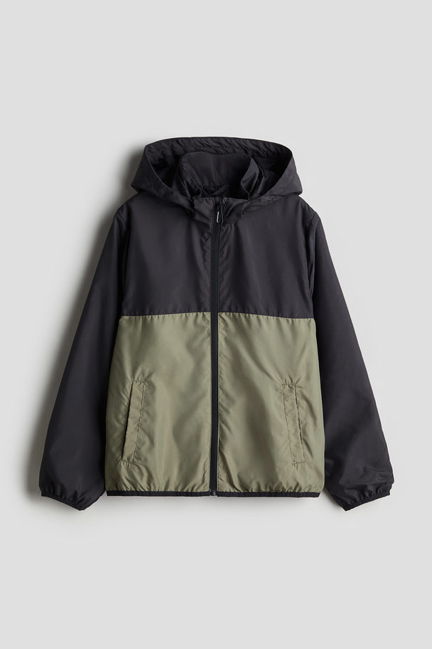 H&M Windjacke mit Kapuze Schwarz/Khakigrün