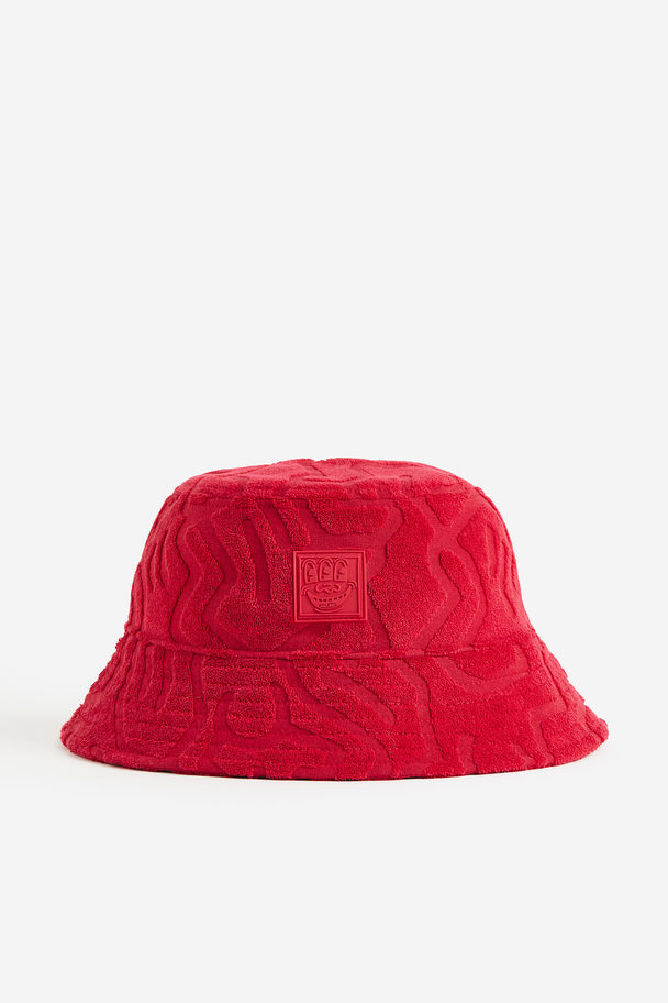 H&M Bucket Hat aus Frottee Rot/Keith Haring