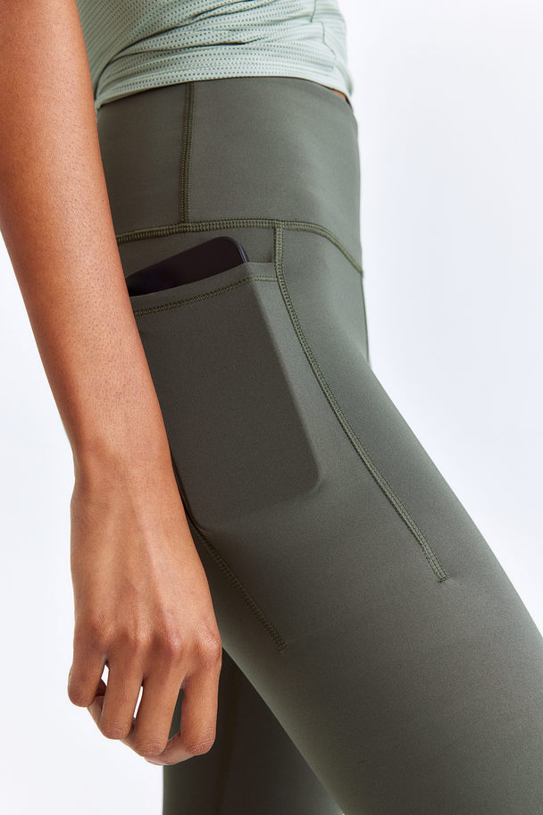 H&M DryMove ™ Sportleggings mit Taschendetail Khakigrün