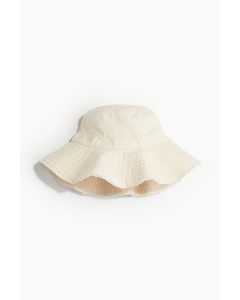 Bucket Hat aus Baumwolle mit Fransenkante Hellbeige