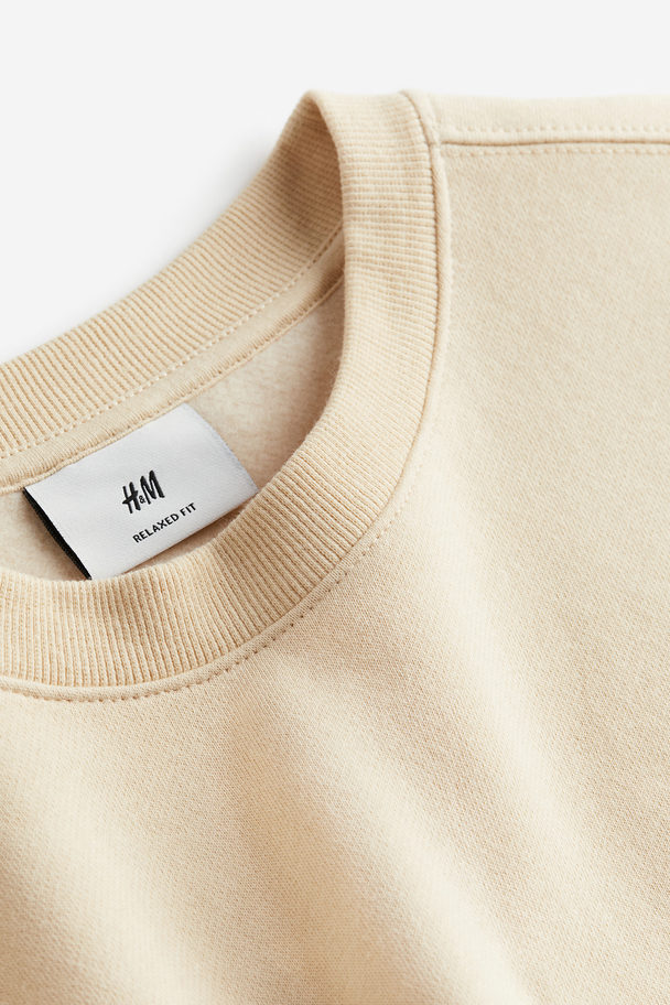 H&M Bedrucktes Sweatshirt in Loose Fit Beige/Bring Peace