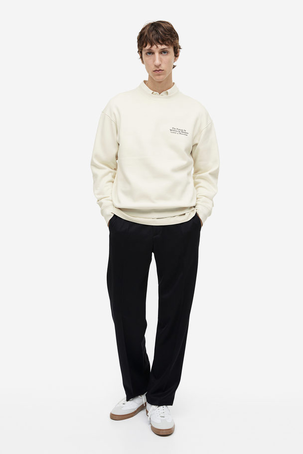 H&M Bedrucktes Sweatshirt in Loose Fit Cremefarben/Stones