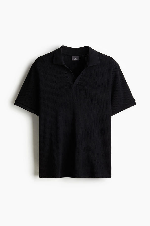 H&M Poloshirt mit Lochmuster in Regular Fit Schwarz