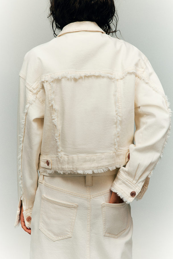H&M Oversized Jeansjacke mit Fransenkanten Weiß