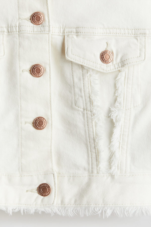 H&M Oversized Jeansjacke mit Fransenkanten Weiß